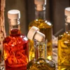 Close-up of several glass bottles with cork stoppers, filled with colorful liquids. Voir les images du produit