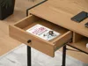 A close-up view of an open drawer in a wooden desk, revealing a book inside. The desk has a black metal frame. Podgląd zdjęcia produktu