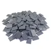 A pile of dark gray LEGO-like baseplates on a white background. Produktbild-Vorschau