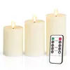 Three ivory LED candles of varying heights are displayed on a white background, with a remote control placed in front of the largest candle. Produktbild-Vorschau