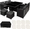 A black rattan dining set with a glass-topped table and chairs, along with ottomans and a cover, arranged on a white background. Náhled obrázku produktu
