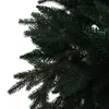 A close-up view of the branches and needles of a green artificial Christmas tree. Náhled obrázku produktu
