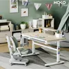 A child's study area with a desk, chair, and shelving unit. Produktbild-Vorschau