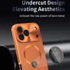 Close-up of the back of an orange iPhone case with a metallic finish, showing the camera module and a MagSafe ring. An inset shows the Apple logo. Náhled obrázku produktu