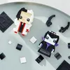Two LEGO BrickHeadz figures, Cruella and Maleficent, are arranged on a light gray surface with scattered black and white LEGO bricks. Anteprima dell’immagine prodotto