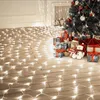 Christmas tree with presents and lights on a wooden floor. Produktbild-Vorschau