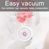 A small white vacuum sealer with a red power button is shown sealing food in a clear plastic bag. Produktbild-Vorschau