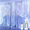 A curtain of white LED string lights draped over sheer white curtains, with a remote control and USB connector in the foreground. Náhled obrázku produktu