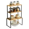 A three-tiered shelf unit holding kitchenware and spices, presented against a white background. Produktbild-Vorschau