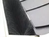 A close-up view of a gutter brush installed in a gutter, with roof shingles visible in the background. Produktbild-Vorschau