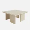 A square coffee table made of travertine-look material, presented against a plain white background. Produktbild-Vorschau