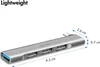A silver USB hub with multiple ports, shown with dimensions indicated by measurement lines and text. Produktbild-Vorschau