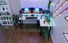 A modern gaming desk setup with a large curved monitor, computer tower, and decorative lighting. Anteprima dell’immagine prodotto