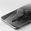 A key rests on a smartphone screen protector, which is placed on a smartphone. Produktbild-Vorschau