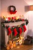 A festive Christmas fireplace decorated with stockings, candles, and a wreath. Náhled obrázku produktu