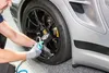 A person is checking the tire pressure of a car. Náhľad obrázku produktu