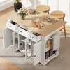 A white kitchen island with a wooden countertop is shown in a room with natural light. The island has open doors and drawers, revealing shelves stocked with jars and boxes. Two wooden stools are placed at the countertop. Anteprima dell’immagine prodotto