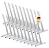 A group of metal rolladen suspension springs arranged diagonally on a white background, with a German flag tag attached to one of them. Produktbild-Vorschau