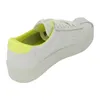 A single white sneaker with yellow accents is shown from a side-rear angle against a white background. Produktbild-Vorschau