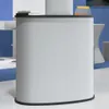 A white counter with a black top, on a white and blue floor. There are some books and a small orange and clear triangular object on the counter. Voir les images du produit