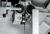 A close-up view of the blade guide mechanism on a band saw. Anteprima dell’immagine prodotto