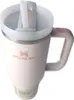 A close-up, top-down view of a cream-colored Stanley Quencher H2.0 Flowstate tumbler with a straw and handle. Podgląd zdjęcia produktu