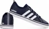 A pair of navy blue Adidas sneakers with white stripes, shown against a white background. Náhľad obrázku produktu
