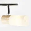 A close-up of a modern light fixture with a wooden base and a frosted glass shade. Produktbild-Vorschau