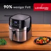 A LEHMANN Home air fryer is shown on a wooden table, with a plate of grilled vegetables and a bunch of kale nearby. Text overlays highlight a feature of the product. Produktbild-Vorschau