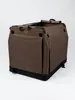 A brown and black foldable dog crate is shown against a white background. Produktbild-Vorschau
