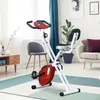 An exercise bike is set up in a living room with furniture and decor. Náhľad obrázku produktu
