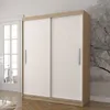 A modern sliding door wardrobe with white doors and a wood-effect frame, set against a wall with a tree-like pattern. A doorway with glass panes is visible to the left. Voir les images du produit
