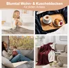 A collage of four images showcasing different scenarios of using Blumtal blankets, including a woman on a bed, breakfast on a tray, a woman with a dog in a camper, and a blanket draped on a sofa. Náhľad obrázku produktu
