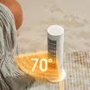 A white tower heater is placed on a rug next to a blanket and an orange stool. A graphic overlay indicates a heating range of 70 degrees. Podgląd zdjęcia produktu
