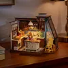 A miniature dollhouse kitchen scene, lit with LED lights, set on a wooden surface. Náhľad obrázku produktu