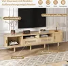 A light wood TV stand with various storage compartments, featuring a television on top and decorative elements. Anteprima dell’immagine prodotto