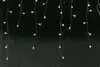 A string of warm white LED lights hanging against a black background. Produktbild-Vorschau