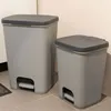 Two grey pedal bins are shown on a tiled floor next to a wall. Náhled obrázku produktu