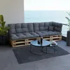 A modern outdoor seating area with a pallet sofa and coffee tables overlooking the ocean. Voir les images du produit