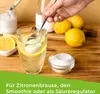 A hand is stirring a glass of water with lemon and a white powder, with lemons and a bowl of powder on a wooden table. Produktbild-Vorschau