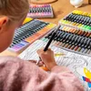 A child is coloring in a book with markers. Produktbild-Vorschau
