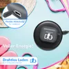 A flat lay of a gray AirPods case on a wireless charger, surrounded by beach accessories like flip-flops and a bikini. Produktbild-Vorschau