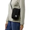 A person wearing a beige fleece jacket and blue jeans, carrying a black crossbody bag. Náhľad obrázku produktu