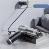 A handheld vacuum cleaner is charging next to a wall outlet and a stack of books on a table. Produktbild-Vorschau