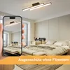 A modern bedroom with a ceiling light fixture, viewed through a smartphone screen. Podgląd zdjęcia produktu