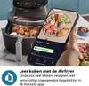 A hand holding a smartphone displaying an air fryer recipe app next to a Philips air fryer. Náhľad obrázku produktu