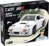 The image shows the packaging of a white CaDA C61022W Mazda FC3S RX-7 building block set, featuring a depiction of the assembled model and an anime-style illustration of a person. Produktbild-Vorschau