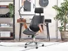 A black office chair with wooden accents is shown in a home office setting, next to a desk and a bookshelf. Anteprima dell’immagine prodotto