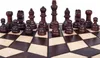 A close-up view of a wooden chessboard with chess pieces arranged on it. Anteprima dell’immagine prodotto