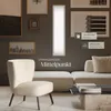 A modern living room with a chair, sofa, and a wall-mounted LED panel. Produktbild-Vorschau